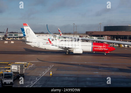A Norwegian Airlines Boeing 737-800 with a portrait of Sonja Henie on the tailplane at Gatwick Airport, Stock Photo