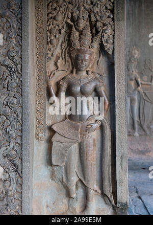 Stone carving of a Khmer queen or goddess with temple headdress or crown. Photographed at Angkor Wat, Cambodia. Stock Photo