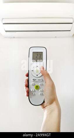 Hand holds air conditioner for concept design. Stock Photo