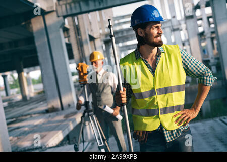 Portrait of construction architects, engineers working on building site Stock Photo