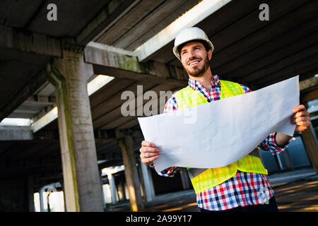 Portrait of construction architect, engineer working on building site Stock Photo