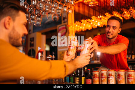 party friends drinking ganzberg beer at bar or pub Stock Photo