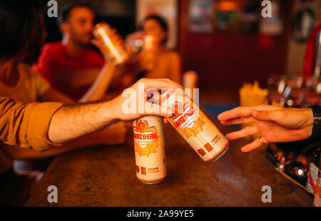 party friends drinking ganzberg beer at bar or pub Stock Photo