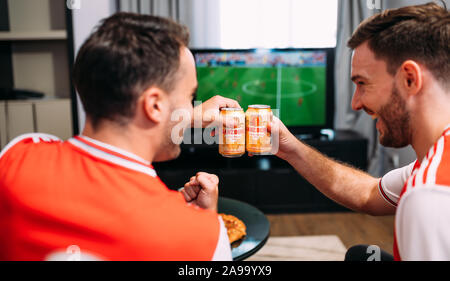 Happy friends drinking ganzberg beer enjoying time together Stock Photo