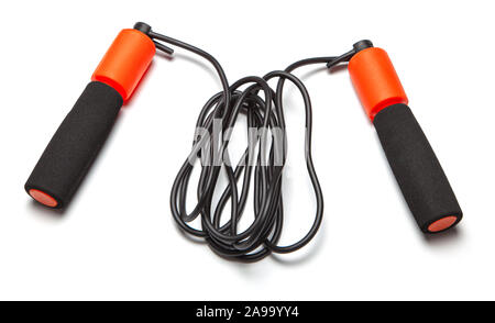 Jump rope. Fun exercises for body health. Orange rope with black cord. Isolated on white background. Stock Photo