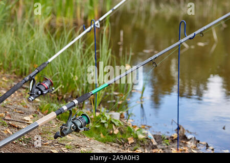 Fishing rod closeup on a prop and water background Stock Photo