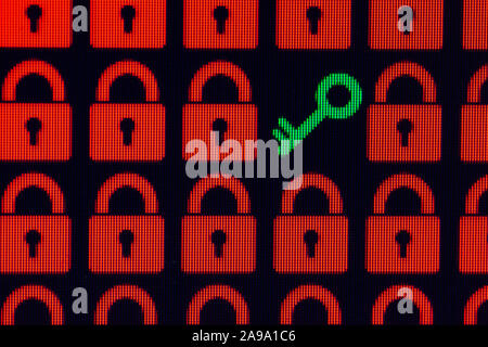 Key as a symbol of access or hacking of open personal information. Red pixel locks and a green key on a black background, close-up. Stock Photo