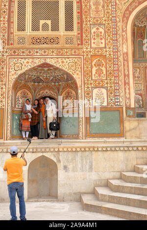 JAIPUR, RAJASTHAN, INDIA - DECEMBER 05, 2017: Indian tourists taking family pictures at Ganesh Pol, main entrance gate to Amber Fort Stock Photo