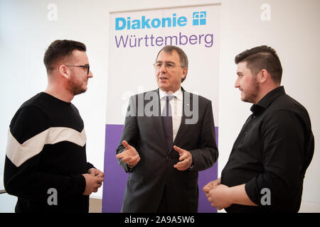 Stuttgart, Germany. 14th Nov, 2019. Ruzhdi Canaj (l) and Ferdinand Dedaj (r) speak with Dieter Kaufmann, CEO of the Diakonisches Werk Baden-Württemberg. Since 2015, more than 260 young Kosovars have begun training in nursing care for the elderly at Baden-Württembergische Diakonie, the welfare association of the Protestant Church. Credit: Tom Weller/dpa/Alamy Live News Stock Photo