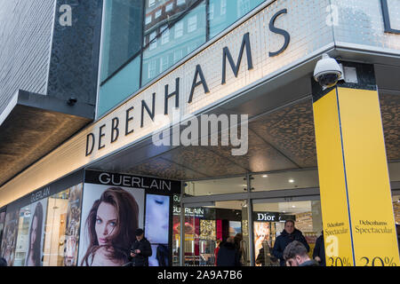 Pre-Christmas shoppers outside Debenhams main entrance on Oxford Street, London, UK Stock Photo