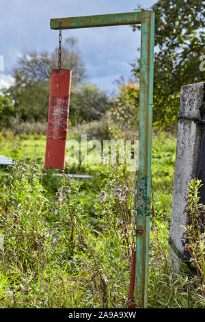 Fire bell installed in a public place, on a rural street, designed to alarm when emergencies and alert the public about the disaster. Stock Photo