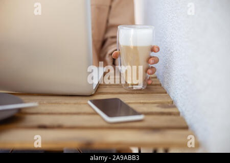 Freelancer working during her breakfast in the cafe Stock Photo