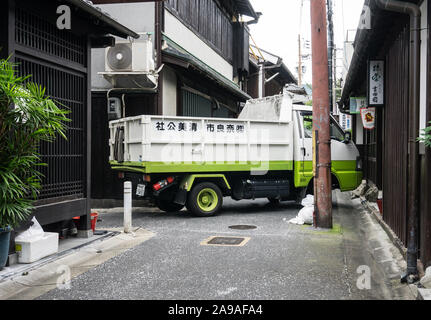 A small garbage truck collecting rubbish in the narrow streets of Nara, in central Japan. Stock Photo