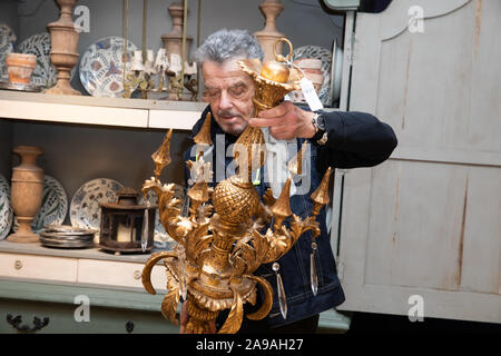 London,UK,14th November 2019,Photocall at Bonhams with Interior designer, Nicky Haslam with his impressive collection from the Hunting Lodge where he has lived since 1978. It featured an Italian carved Giltwood and Gesso Chandelier. The sale takes place on Wednesday 20th November.Credit Keith Larby/Alamy Live News Stock Photo