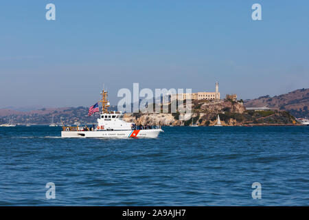 US Coastguard patrol boat, Hawksbill, passes by Alcatraz prison, in San Francisco bay, California, United States of America. USA Stock Photo