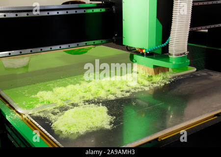 Plexiglass milling on CNC machines. A modern CNC machine processes acrylic at a furniture factory. Plexiglass processing on the CNC wall. Modern 3D te Stock Photo