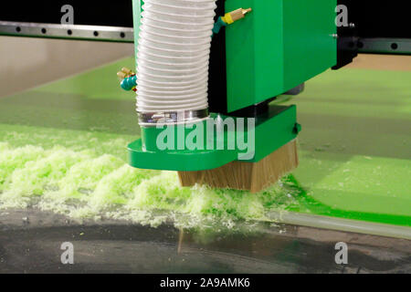 Plexiglass milling on CNC machines. A modern CNC machine processes acrylic at a furniture factory. Plexiglass processing on the CNC wall. Modern 3D te Stock Photo