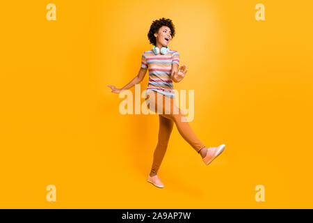 Full body photo of positive cheerful crazy mulatto brown hair girl have headset listen radio melody song music dance feel content expression wear Stock Photo