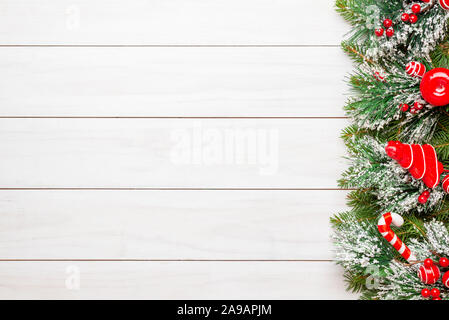 Christmas tree decorations on white wooden desk. Christmas background with copy space. Stock Photo