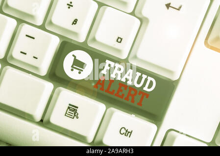 Conceptual hand writing showing Fraud Alert. Concept meaning security alert placed on credit card account for stolen identity White pc keyboard with n