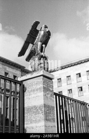 Taking a walk through Berlin, here: sculpture of eagle with swastika in front of the deaprtment of aviation, Germany 1930s. Stock Photo