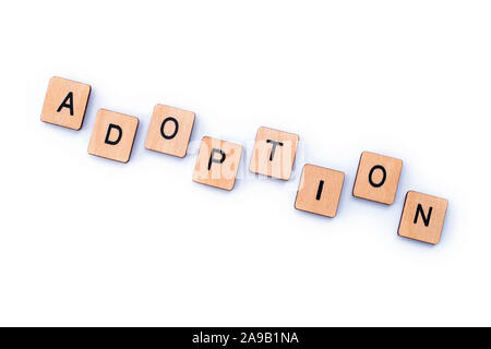 The word ADOPTION, spelt out with wooden letter tiles. Stock Photo