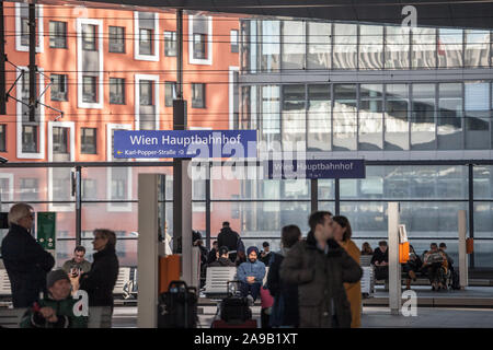 VIENNA, AUSTRIA - NOVEMBER 6, 2019: Crowd of people sitting and waiting for a train on the platforms of Wien Hauptbahnhof, the main train station of V Stock Photo