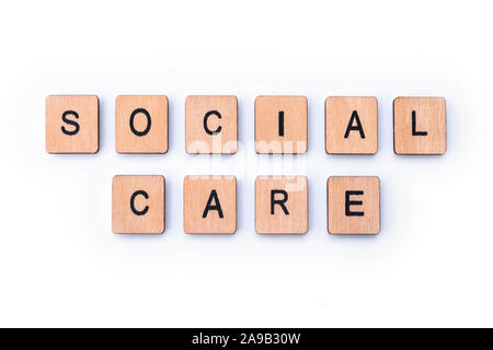 SOCIAL CARE, spelt with wooden letter tiles. Stock Photo