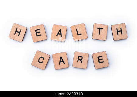 HEALTH CARE, spelt with wooden letter tiles. Stock Photo