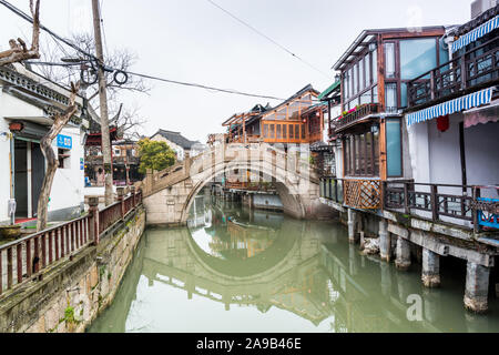 Stone bridge and old buildings in Zhujiajiao, an ancient water town in Shanghai, best known for its bridges, built during Ming and Qing Dynasties, the Stock Photo