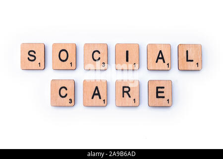 London, UK - February 6th 2019: SOCIAL CARE, spelt with wooden letter tiles. Stock Photo