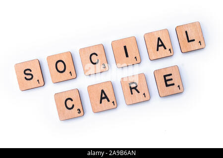 London, UK - February 6th 2019: SOCIAL CARE, spelt with wooden letter tiles. Stock Photo