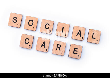 London, UK - February 6th 2019: SOCIAL CARE, spelt with wooden letter tiles. Stock Photo