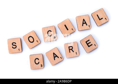London, UK - February 6th 2019: SOCIAL CARE, spelt with wooden letter tiles. Stock Photo