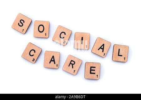 London, UK - February 6th 2019: SOCIAL CARE, spelt with wooden letter tiles. Stock Photo