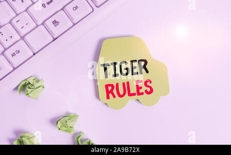 Handwriting text writing Tiger Rules. Conceptual photo Willpower and demonstratingal strength Resistance to imperial rule Green note paper in the shap Stock Photo