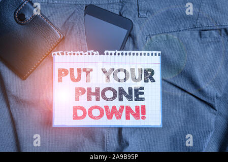 Writing note showing Put Your Phone Down. Business concept for end telephone connection saying goodbye caller Smartphone device inside trousers front Stock Photo