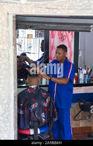 MEDELLIN, COLOMBIA - SEPTEMBER 12, 2019: Unidentified man having haircut at Medellin, Colombia. Medellin is capital of Colombia’s mountainous Antioqui