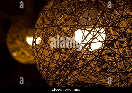 Romantic cotton ball lamp made from cotton thread with jumbo rattan ball for home, bedroom decoration. Modern, cozy home concept. Stock Photo