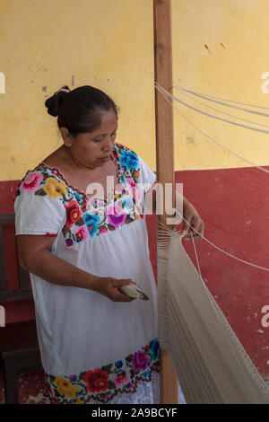 YUCATAN, MEXICO. OCT 22 2017. Mayan woman working on hammock. Weaving is a tradition in Yucatan. Mayan descendants live off this ancient tradition. Stock Photo