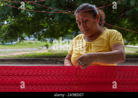 YUCATAN, MEXICO. OCT 22 2017. Mayan woman working on hammock. Weaving is a tradition in Yucatan. Mayan descendants live off this ancient tradition. Stock Photo