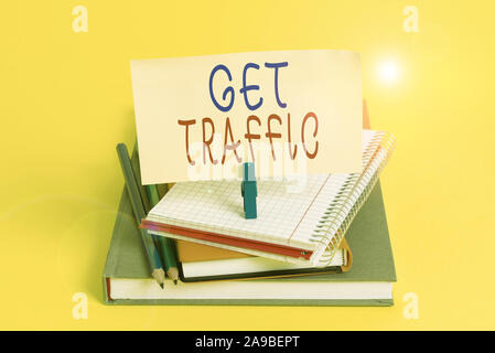 Conceptual hand writing showing Get Traffic. Concept meaning amount of data sent and received by visitors to a website Book pencil rectangle shaped re Stock Photo