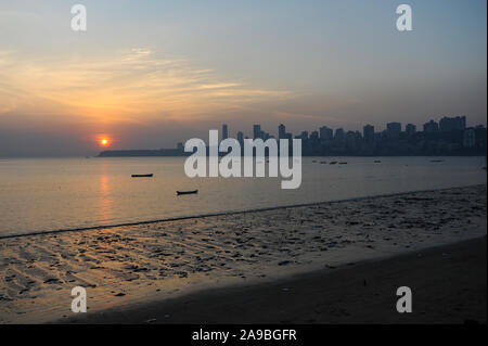 12.12.2011, Mumbai, Maharashtra, India - Sunset at Chowpatty Beach along Marine Drive with the skyline of Malabar Hill in the background. 0SL111212D00 Stock Photo