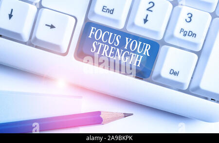 Conceptual hand writing showing Focus Your Strength. Concept meaning Improve skills work on weakness points think more White pc keyboard with note pap Stock Photo