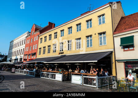 Malmo, Sweden - August 28, 2019: Lilla Torg, a square with many bars, restaurants and shops in the old town of Malmö with people around in Sweden Stock Photo