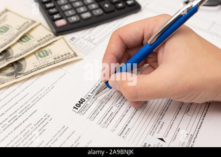 Man filling US tax form in office. Tax income concept Stock Photo