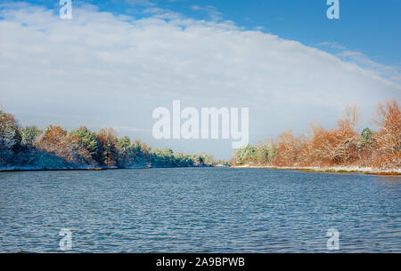 River landscape in winter and tree branches covered with white frost. Winter landscape on a sunny day. Stock Photo