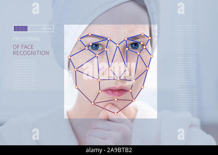 Biometric verification of a modern young woman. The Concept of a new technology of face recognition on polygonal grid is constructed in the points. Stock Photo