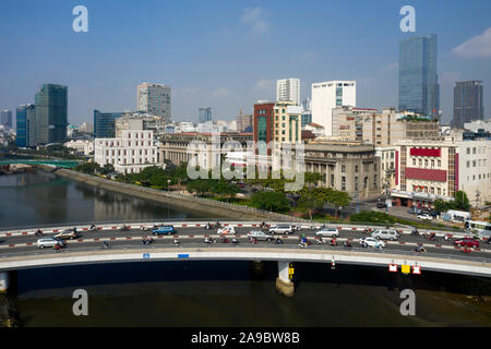 Wide Drone shot of Morning traffic on Khanh Hoi Bridge over Ben Nghe Canal separating districts four and one in Ho Chi Minh City. Stock Photo