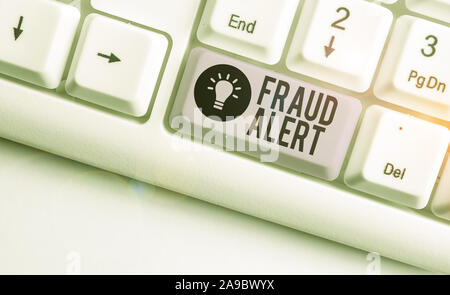 Text sign showing Fraud Alert. Business photo showcasing security alert placed on credit card account for stolen identity White pc keyboard with empty